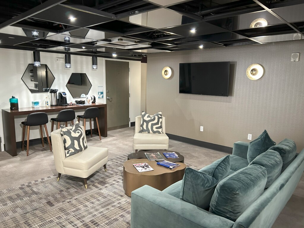 Green room lounge with tables, couch and coffee