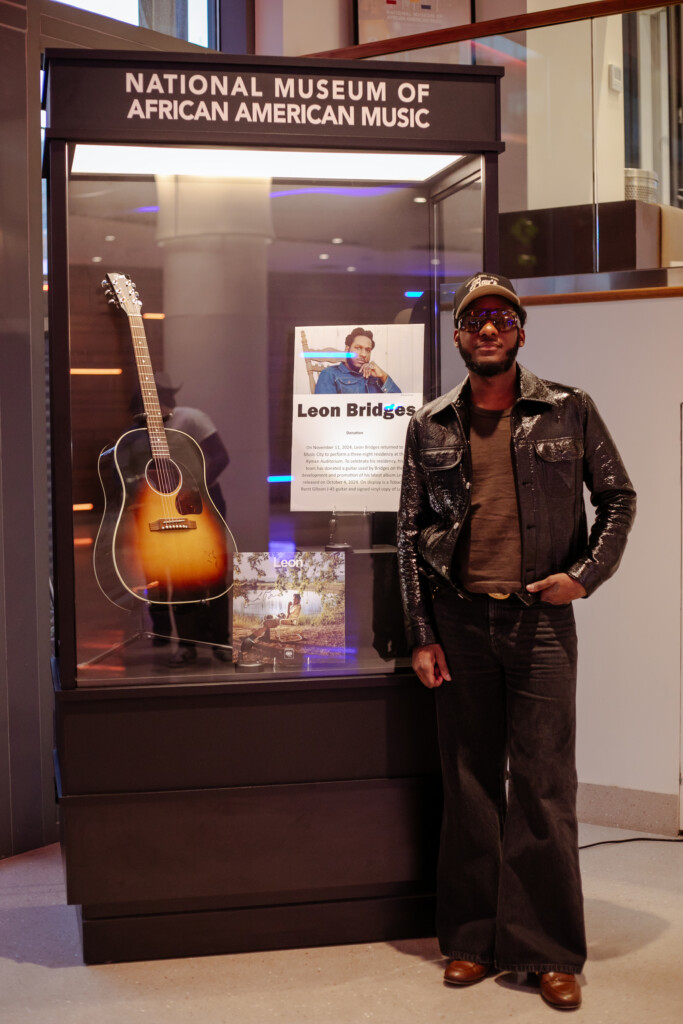 Leon Bridges in front of glass display case