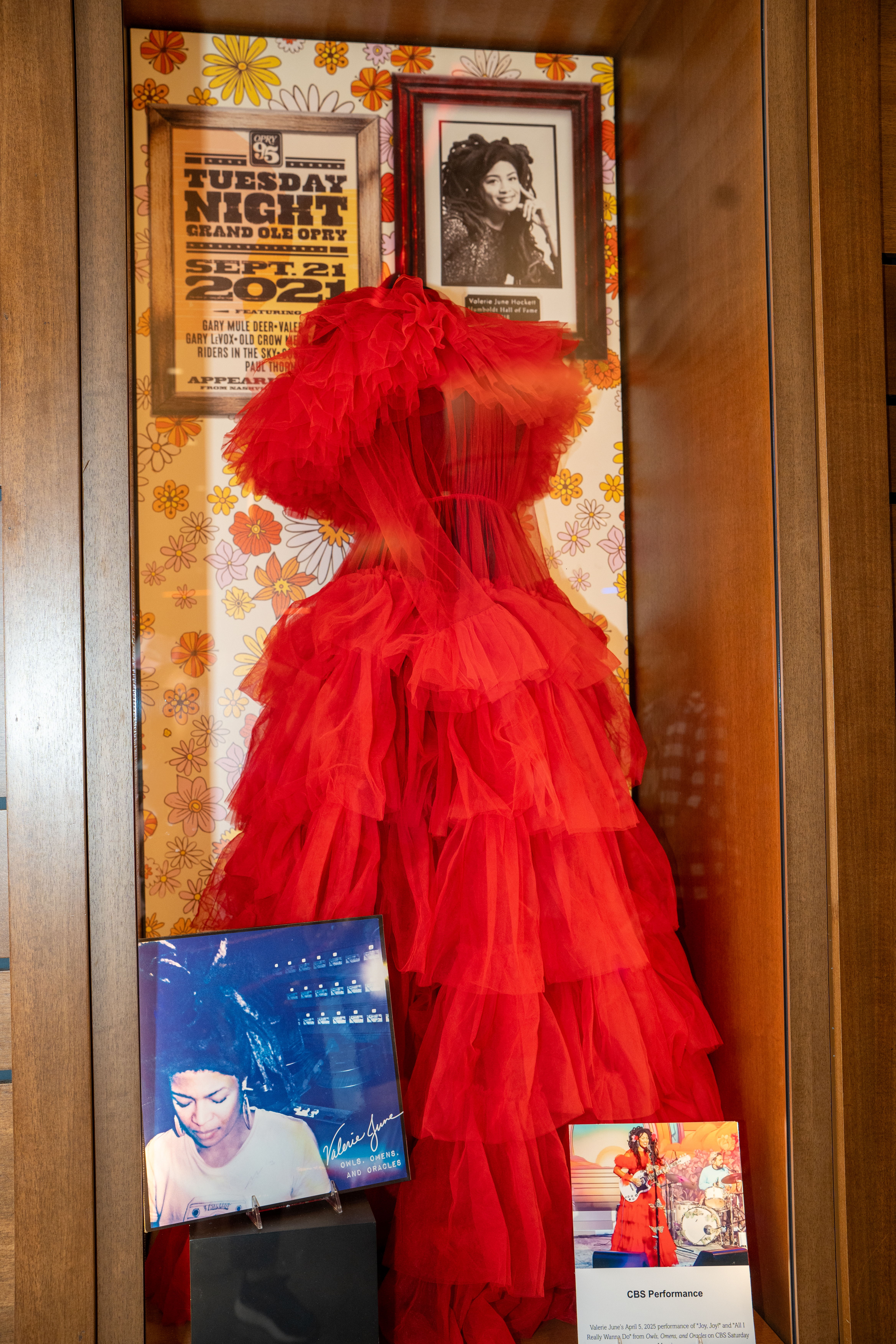 exhibition case containing performance dress, record, and concert poster