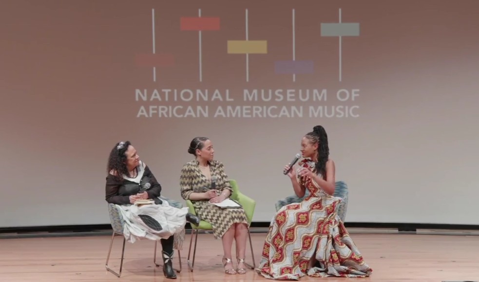 artists and moderator on stage speaking