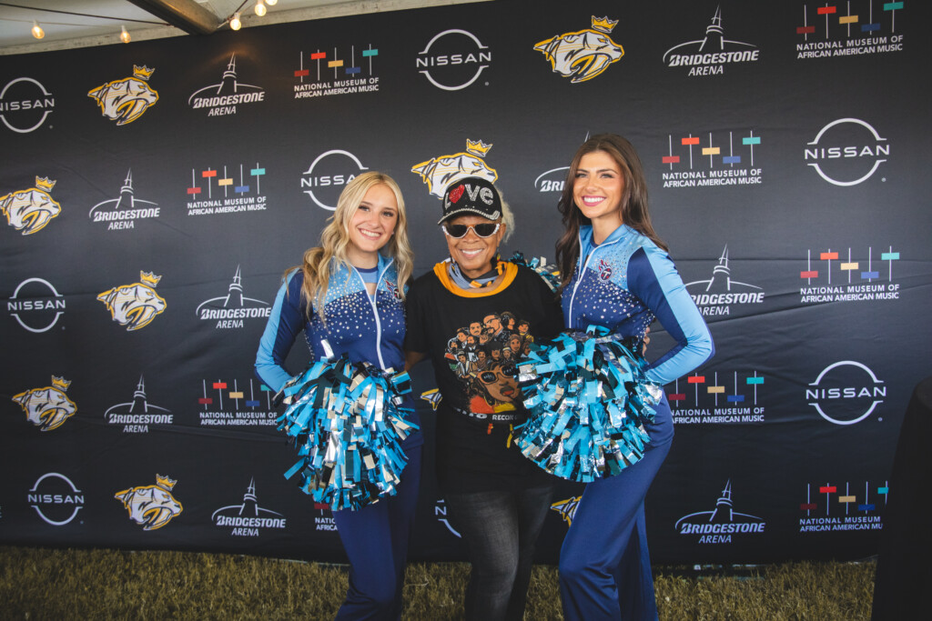 Titans cheerleaders and fan posing for camera