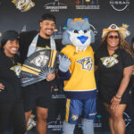 Predadors team fans posing for camera with team mascot