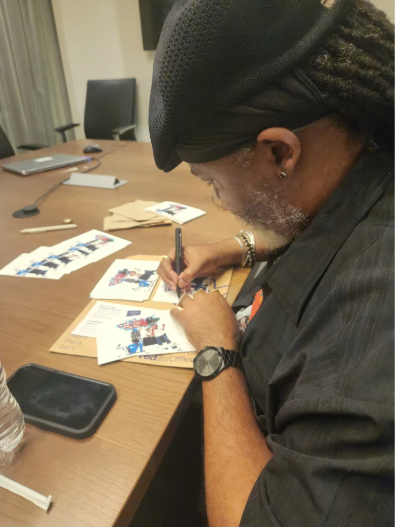 artist signing small drawings