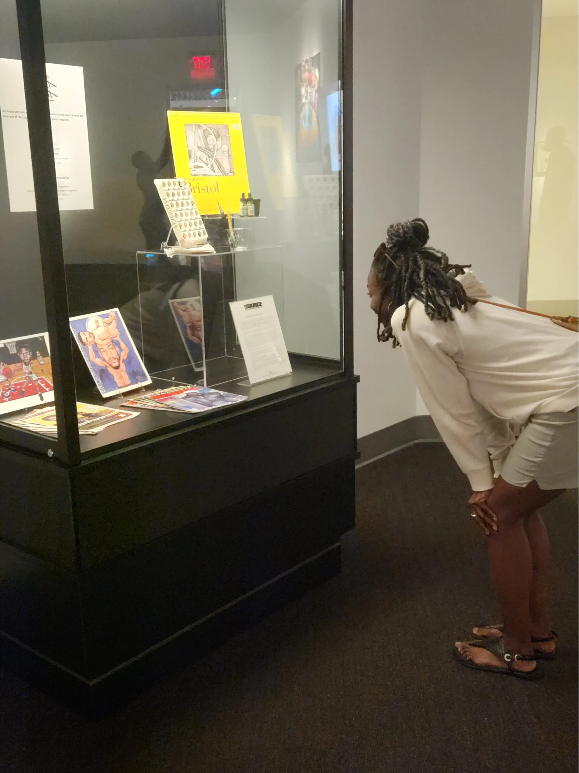 Visitor looking into glass exhibition case