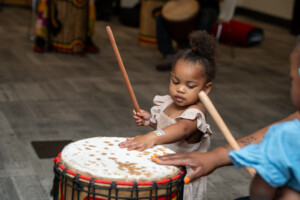 sweet baby child playing drums at NMAAM