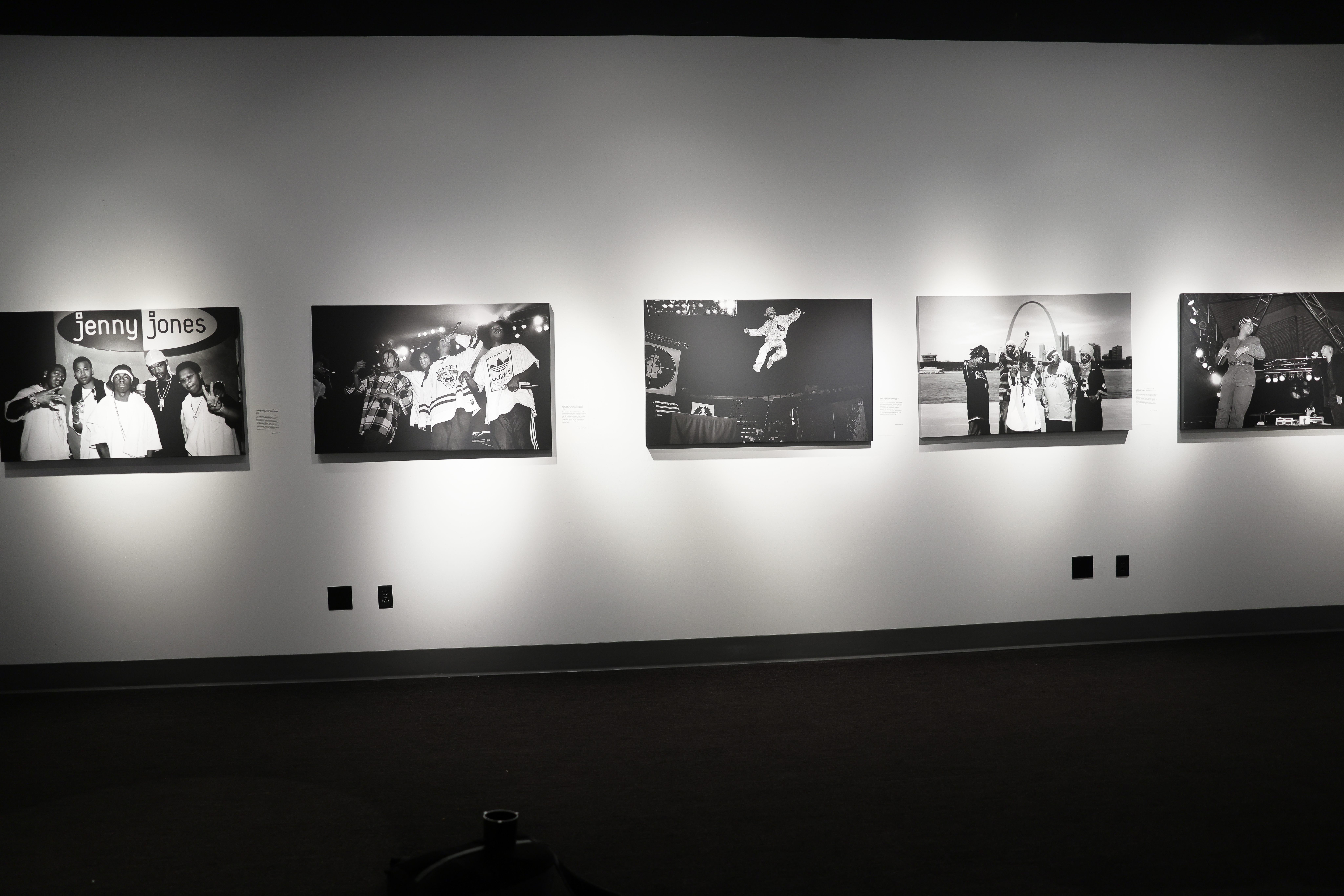 Visitors observe photo exhibit on the gallery walls.