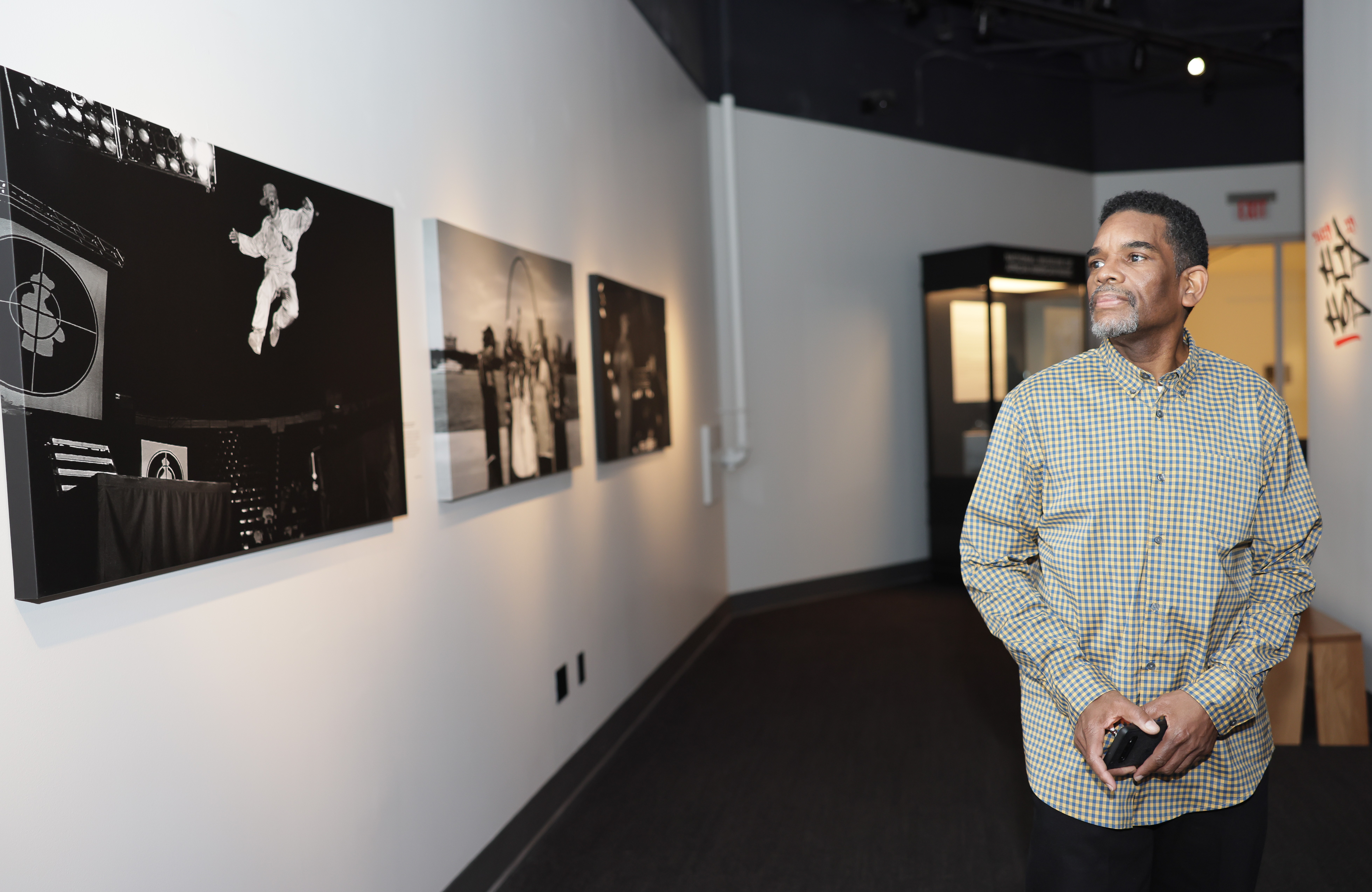 Artist walks through gallery observing his work