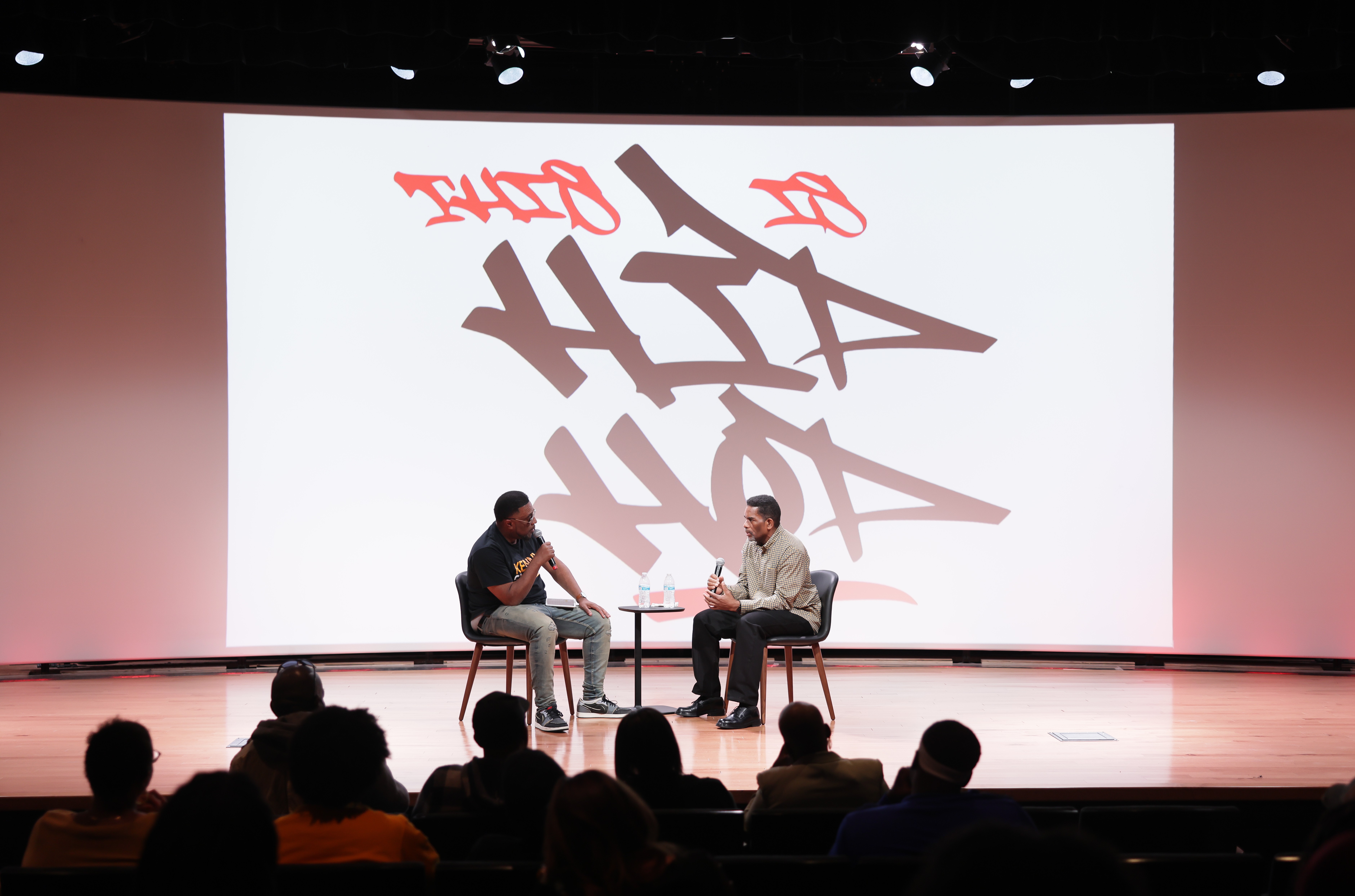 Artist and moderator on stage for Q&A