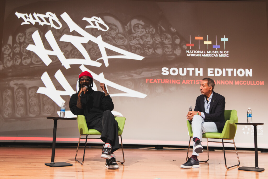 Artist and moderator on stage for Q&A