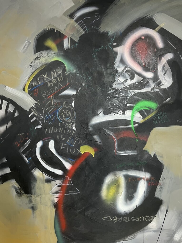 Close up of George Clinton painting with multi colored splattered paint and spray paint.