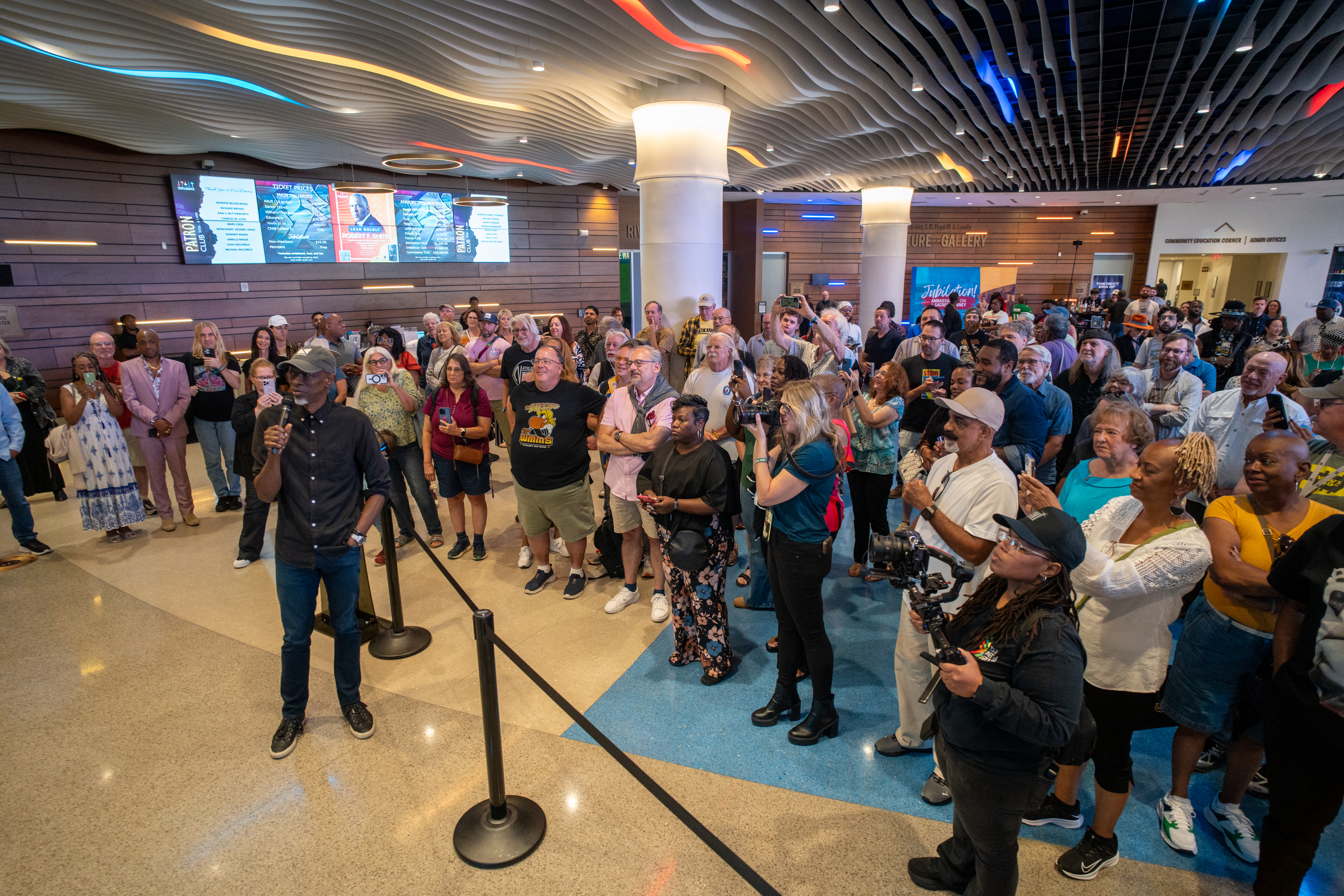 artist and crowd in lobby